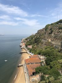 High angle view of buildings by sea against sky