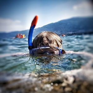 Portrait of boy swimming in sea