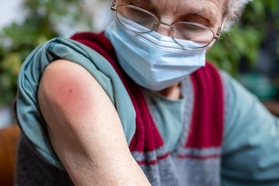 Close-up of senior woman swollen arm