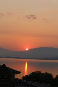 Scenic view of lake against romantic sky at sunset