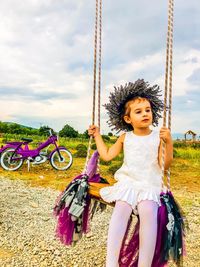 Full length of woman riding girl sitting against sky