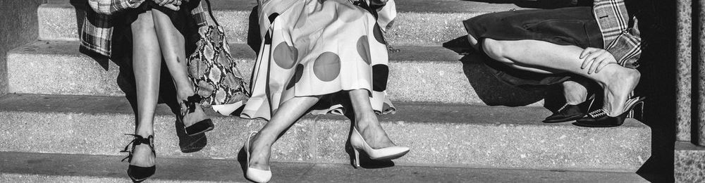 Low section of women sitting on staircase