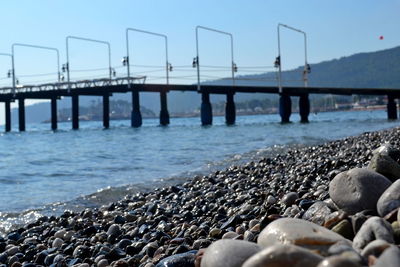 Pier on beach against sky