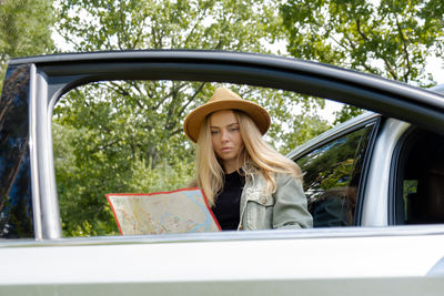 Portrait of young woman in car