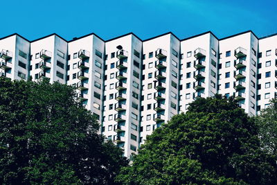 Low angle view of buildings against clear blue sky