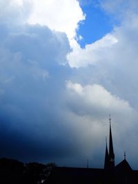 Low angle view of building against cloudy sky