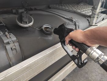 Cropped hand of man repairing car