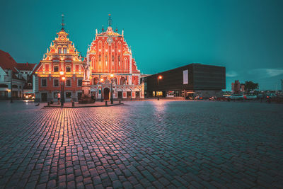 Illuminated building against sky at night