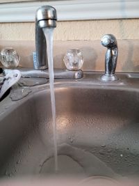 Close-up of water faucet in bathroom