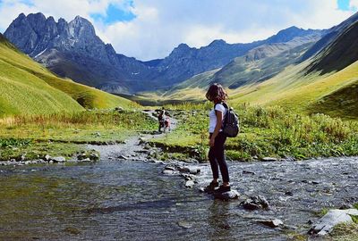 Woman standing on mountain against sky