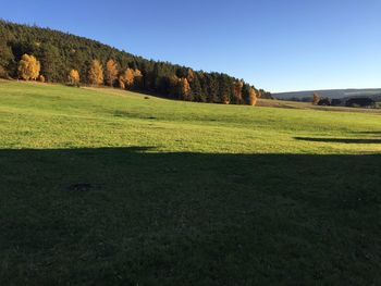 Scenic view of grassy field against cloudy sky