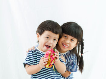 Portrait of happy friends against white background