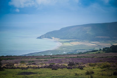 Scenic view of sea and mountains against sky