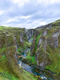 Scenic view of waterfall against sky