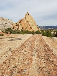 Road by mountain against sky