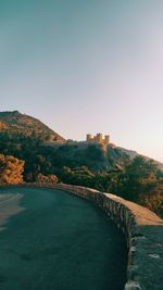 Bridge over mountain against clear sky