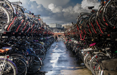 Bicycles parked in row against sky