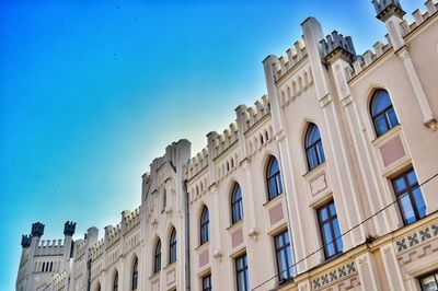 Low angle view of historical building against blue sky