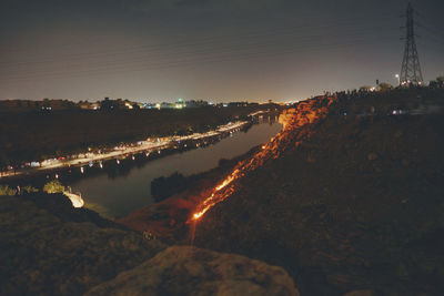 Panoramic view of illuminated city against sky at night