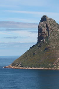 Scenic view of rock formation in sea against sky