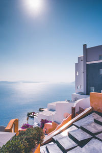 Buildings by swimming pool against clear sky