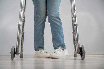 Low section of woman standing on hardwood floor