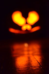 Close-up of lit candle in dark room