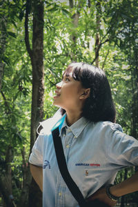 Teenage girl looking away in forest