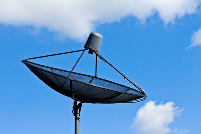 Low angle view of telephone pole against sky