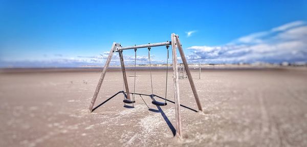 Metallic structure on field against sky