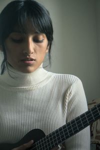 Close-up of girl playing guitar