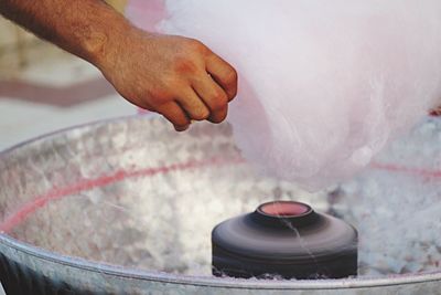 Cropped image of man making cotton candy