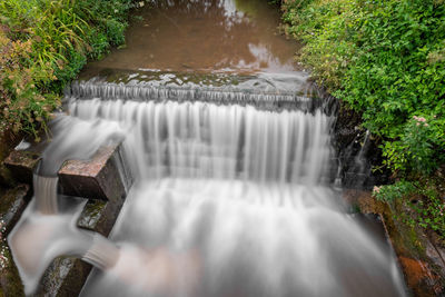 Long exposure of a waterfall on the river lim in lyme regis in dorset