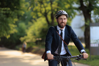 Portrait of young man riding bicycle