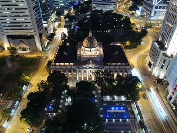 High angle view of city lit up at night