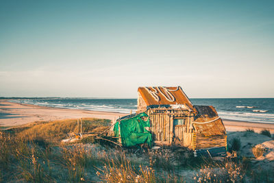 Abandoned built structure on beach against clear sky