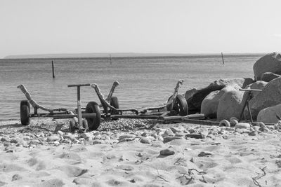 Man working at beach against clear sky