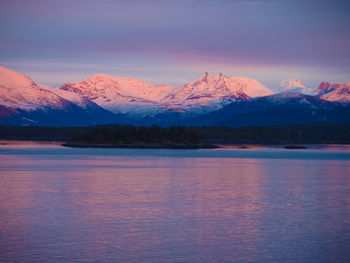 Scenic view of lake against sky at dusk