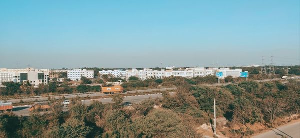 High angle view of buildings against clear blue sky