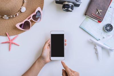 High angle view of person using smart phone on table