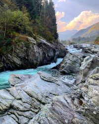 Scenic view of river amidst rocks against sky