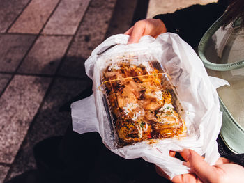 Woman holding takoyaki  we went worship to shrine and bought it at new years day