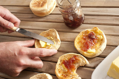 Cropped image of man preparing breakfast on table