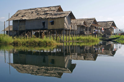 Built structure by lake against sky