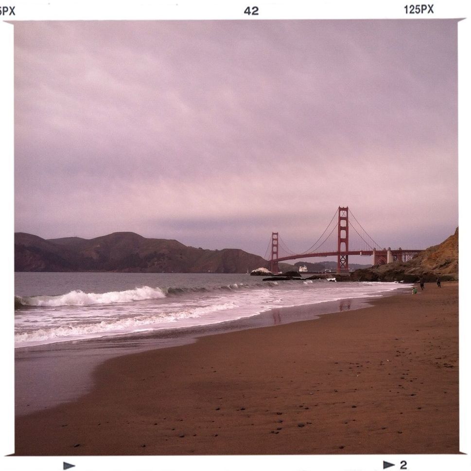 water, sea, sky, suspension bridge, built structure, architecture, beach, connection, bridge - man made structure, shore, travel destinations, wave, auto post production filter, transfer print, engineering, scenics, international landmark, nature, cloud - sky, beauty in nature
