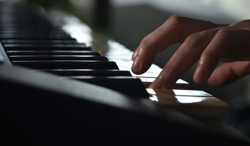 Close-up of hands playing piano