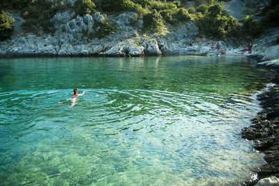 High angle view of woman swimming in lake