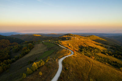 Aerial drone view of winding mountain road at autumn