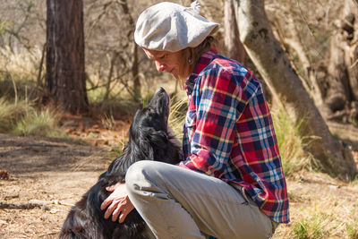 Man with dog against trees