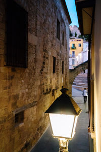 Street amidst buildings in city at night